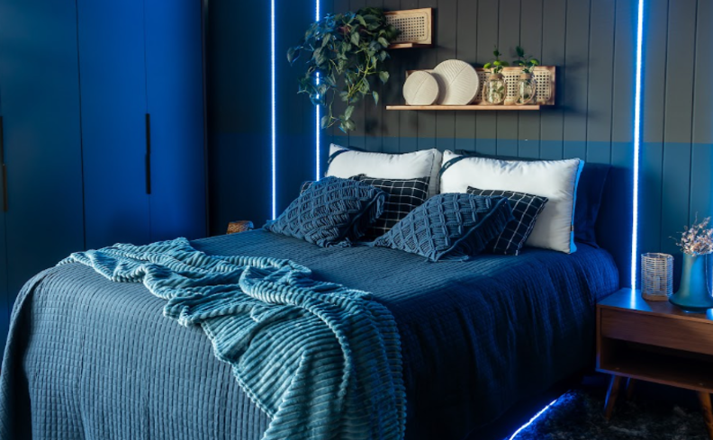 ácaros no colchão como eliminar? Em um quarto com colchão, travesseiros, almofadas, edredom e manta em tons de azul e branco.